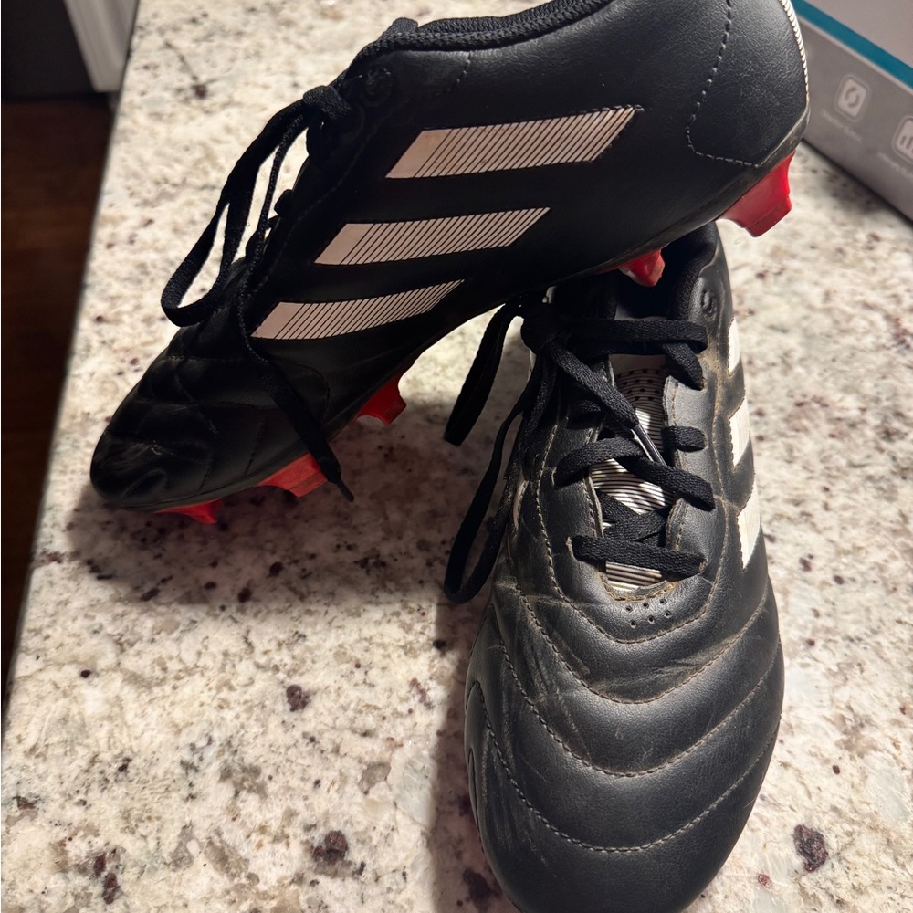 Adidas Black and White Soccer Cleats with Red Soles